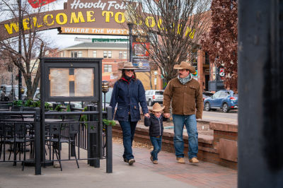 Family walking in downtown Golden wearing Western gear